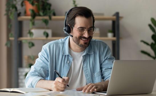man on laptop with headphones on