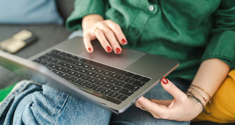 Person using a laptop on their lap.
